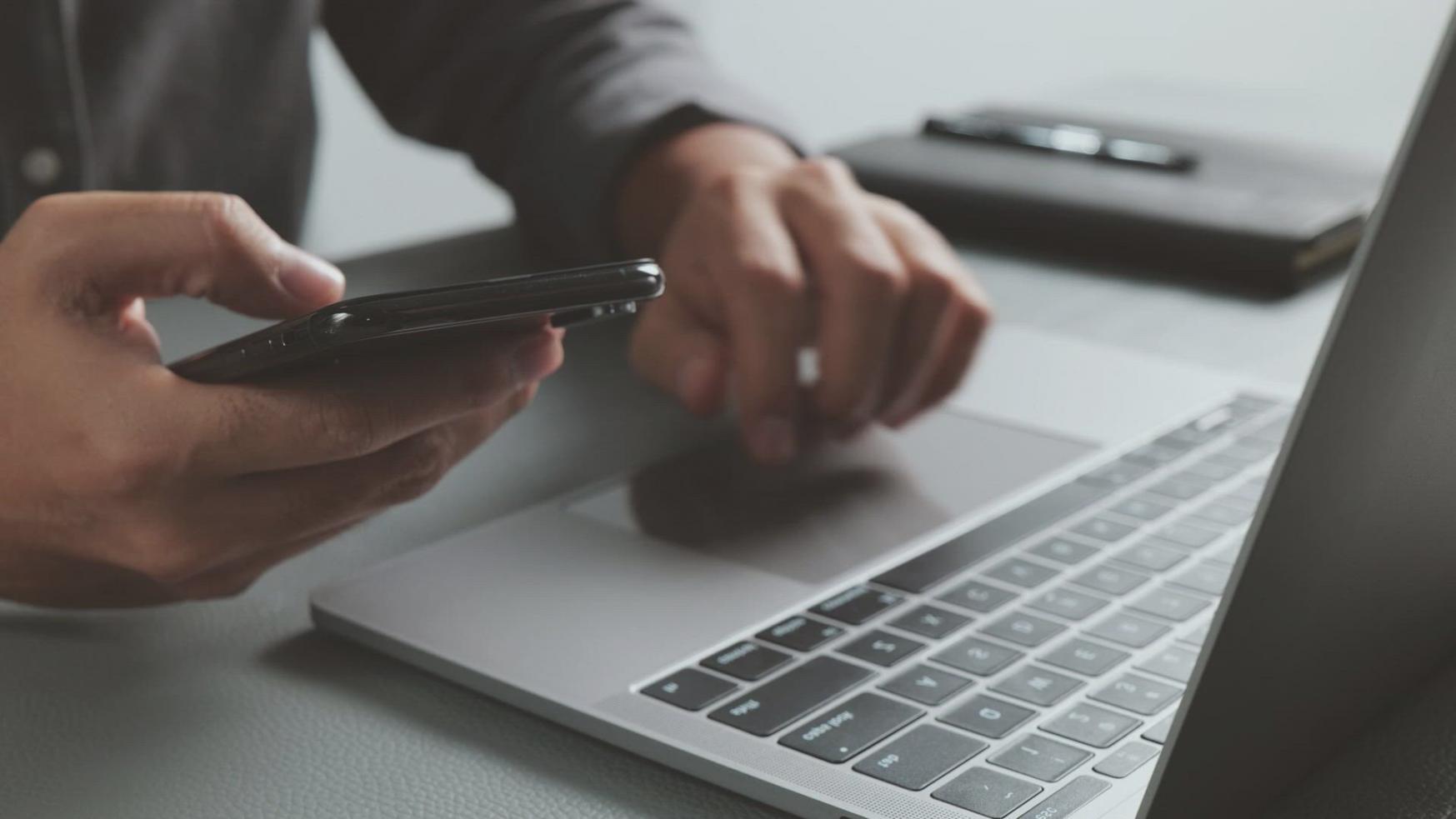 Business professional analyzing automation workflows and financial processes on computer screens